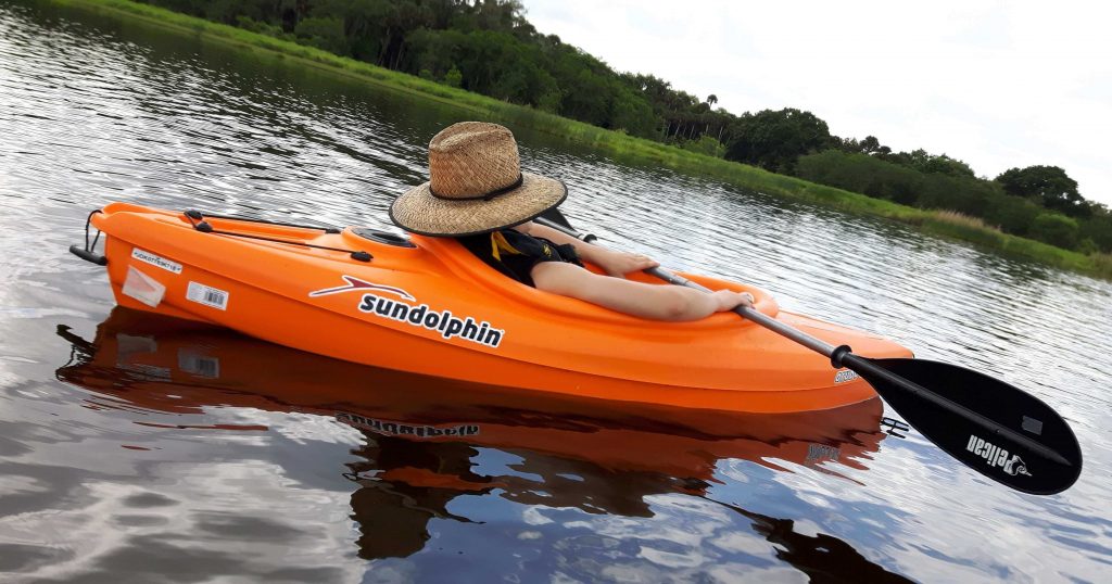 man relaxing in kayak